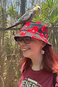 ECORISC PhD student Isla Stubbs with a bird on their hat